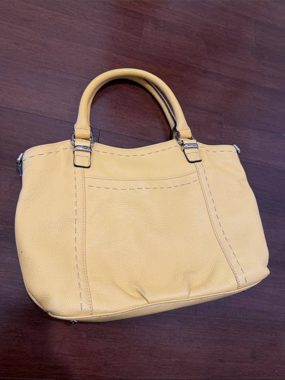 Tignanello yellow pebbled leather purse with silver hardware